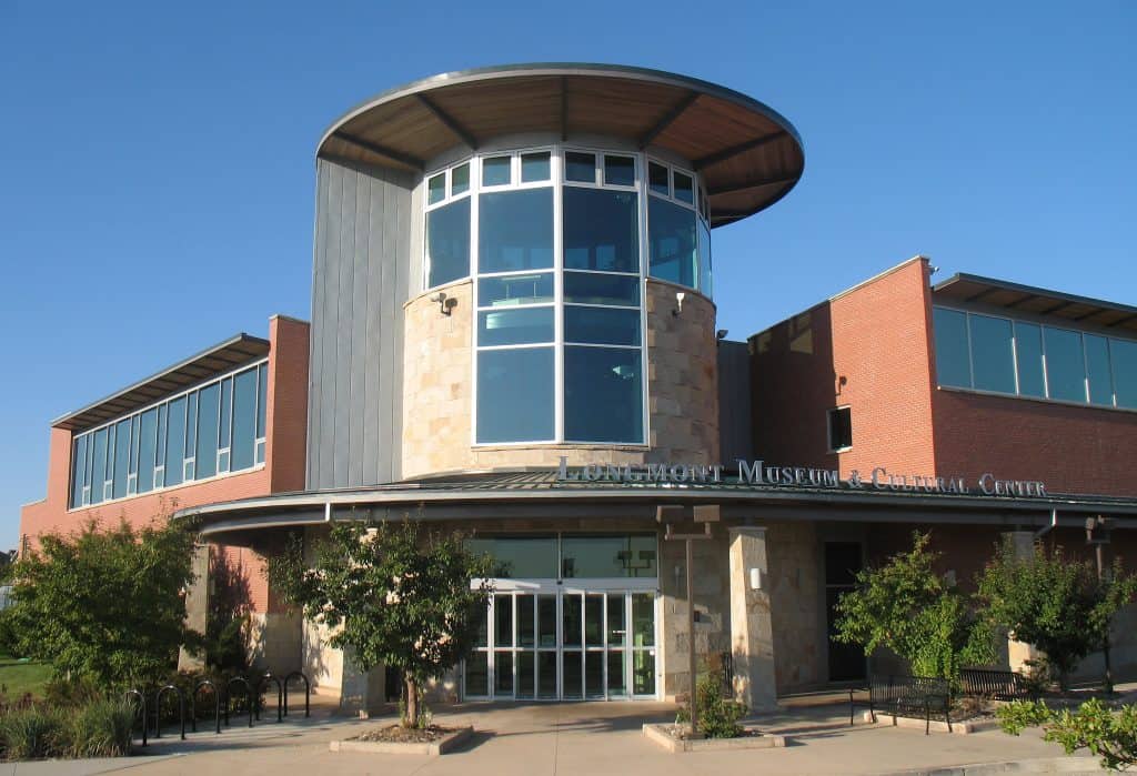 Modern museum entrance with large windows.