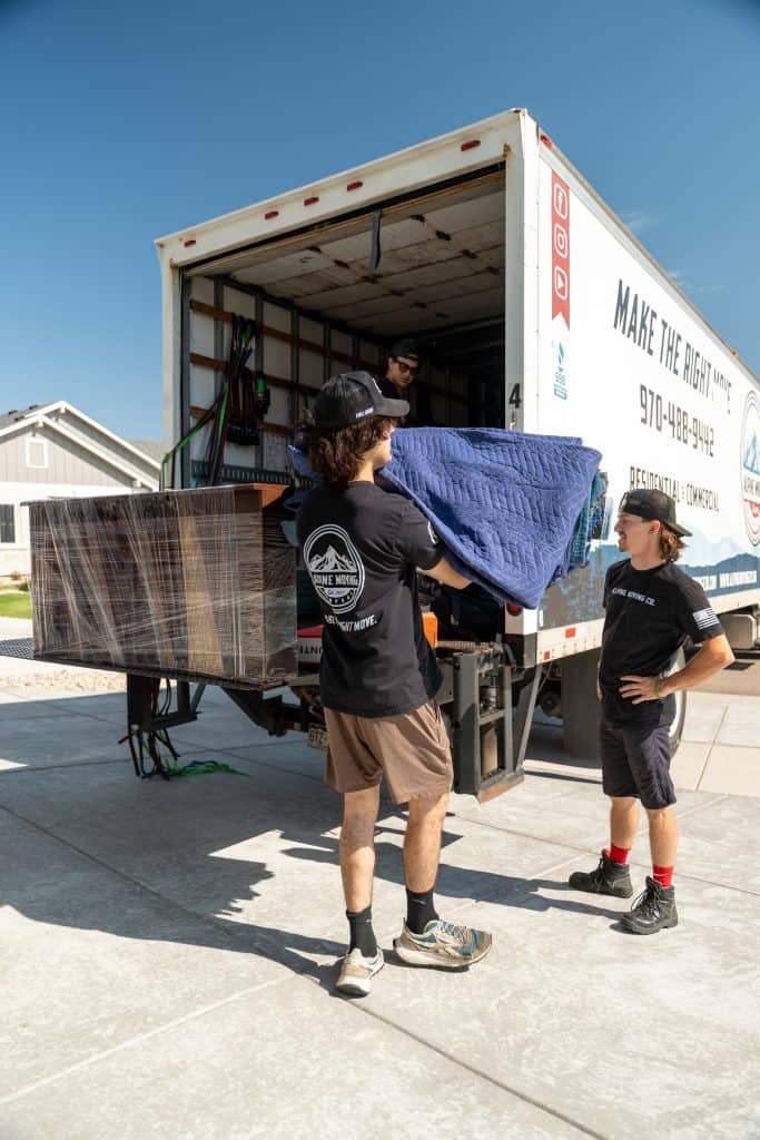 Movers loading furniture into truck