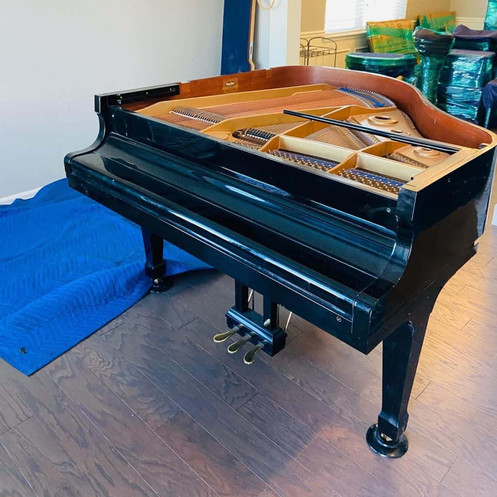 Black grand piano on hardwood floor