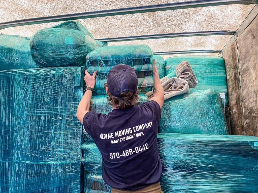 Alpine Moving staff wrapping items to protect them during a Colorado winter move.
