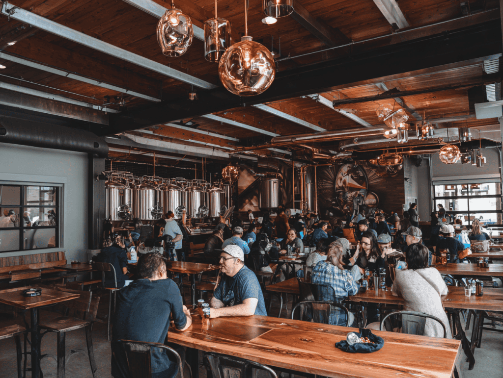 Busy brewery in Fort Collins with people enjoying drinks and conversation.