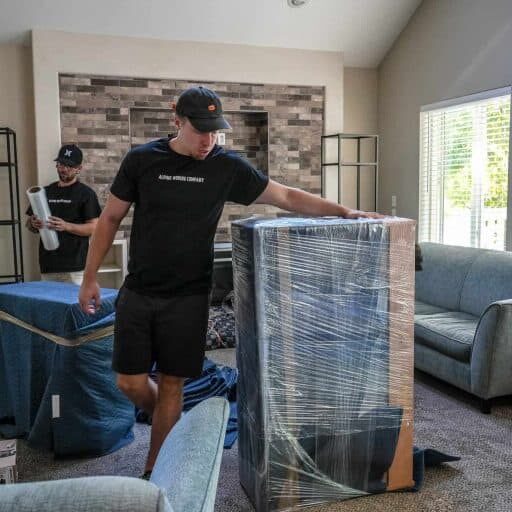 Movers unwrapping furniture for assembly for homeowner concierge services