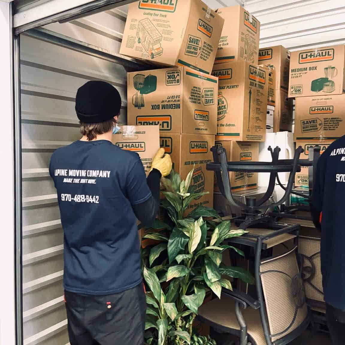 Person organizing packed commercial moving storage.