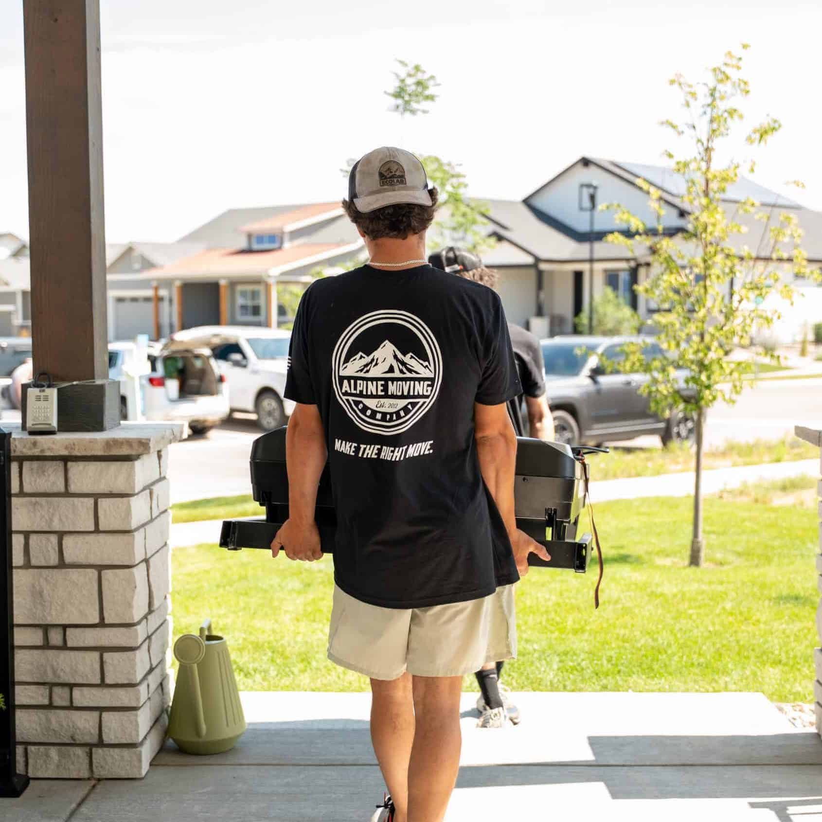 Moving company worker carrying equipment outdoors