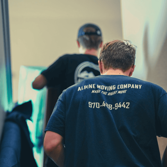 Denver moving company men climbing stairs with furniture