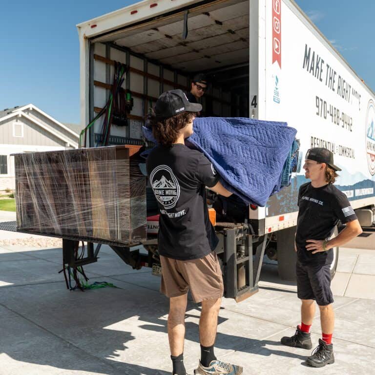Movers loading furniture into truck