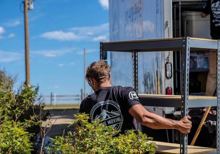 Mover hauling a shelving unit for junk removal services